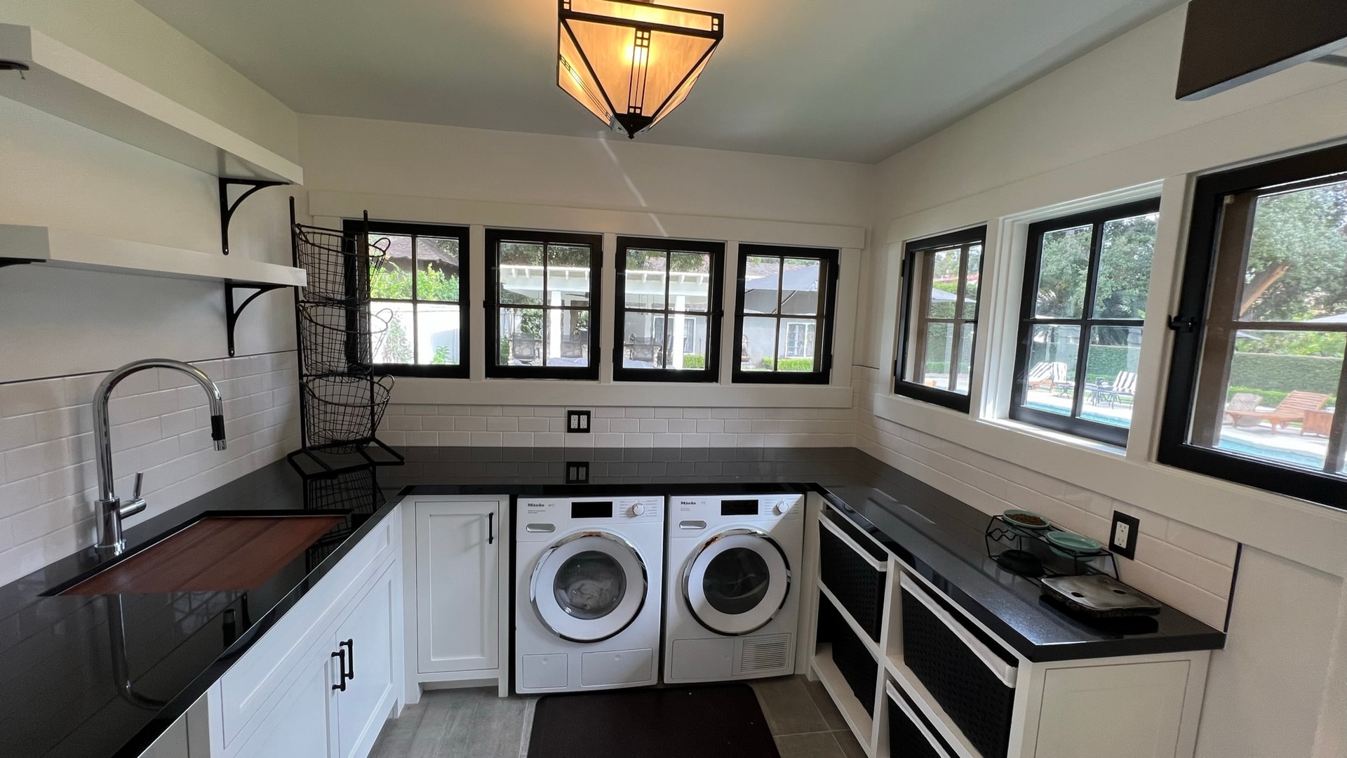 Laundry room with white shaker cabinets and Miele appliances — South Pasadena