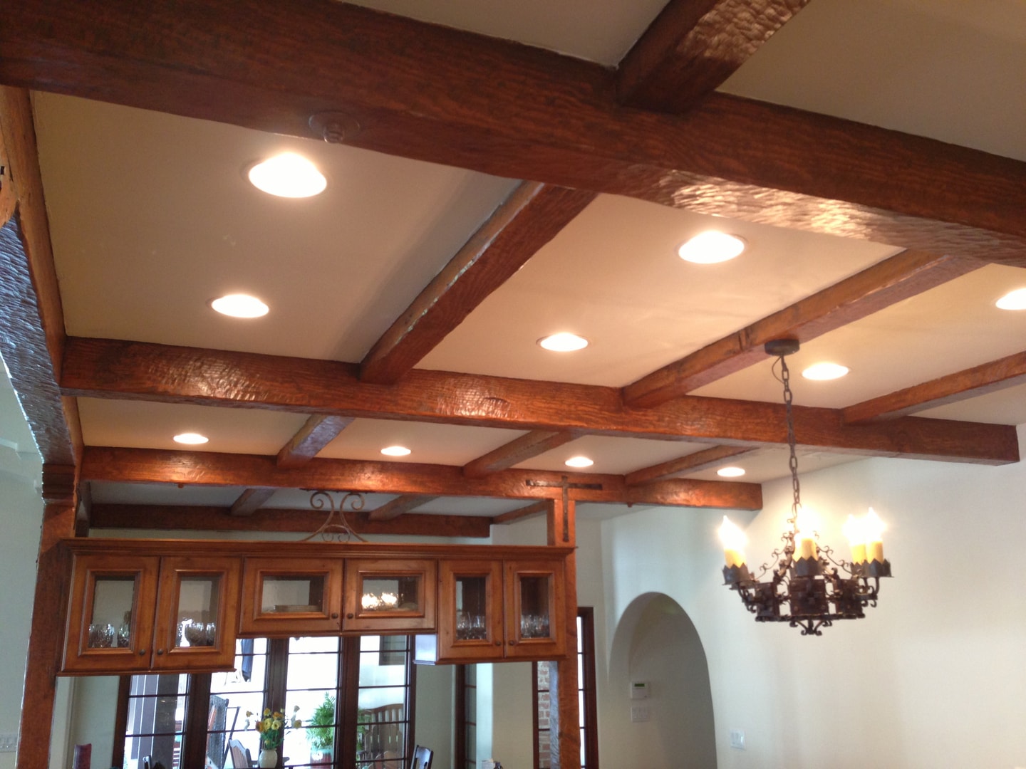 Exposed wood beam ceiling with recessed lighting and custom cabinetry — Studio City